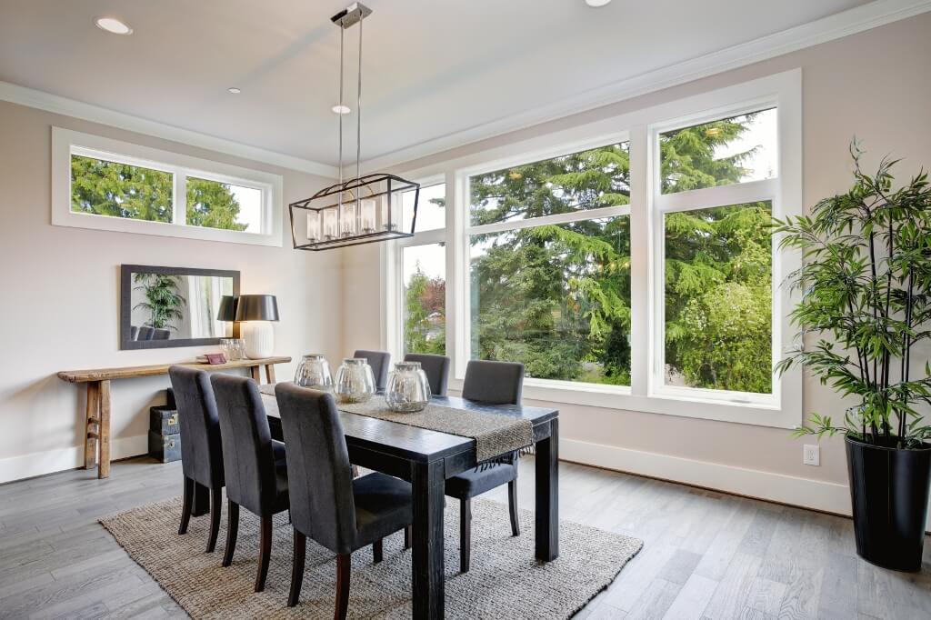 A luxurious modern dining room with large picture windows.