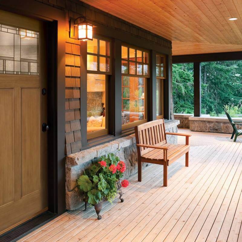 front of a house with a wooden door and casement windows