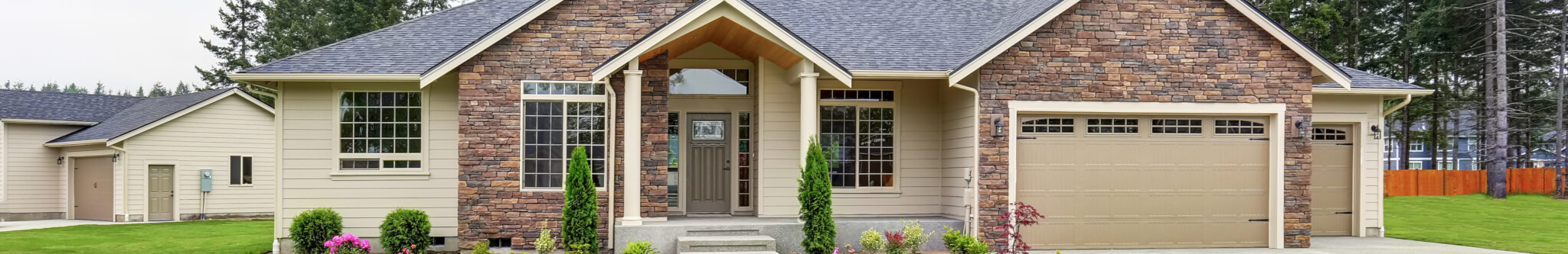 Luxury one level house exterior with brick trim and garage