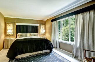 Brown elegant bedroom interior with black bed and cheetah pillow