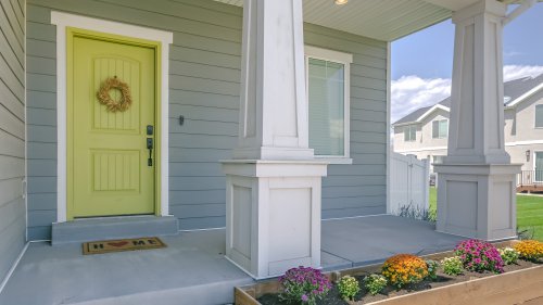 Home with porch and flowers in the garden