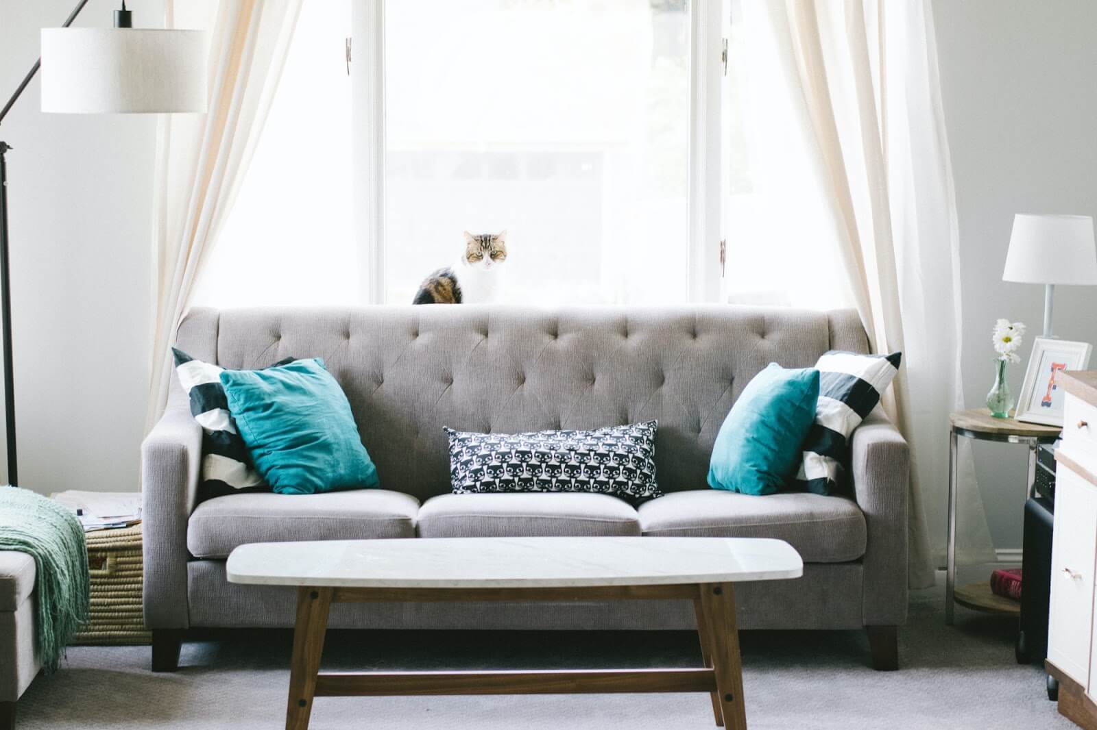 a living room with a couch and windows