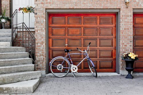 a wood garage door with a bicycle in front of it