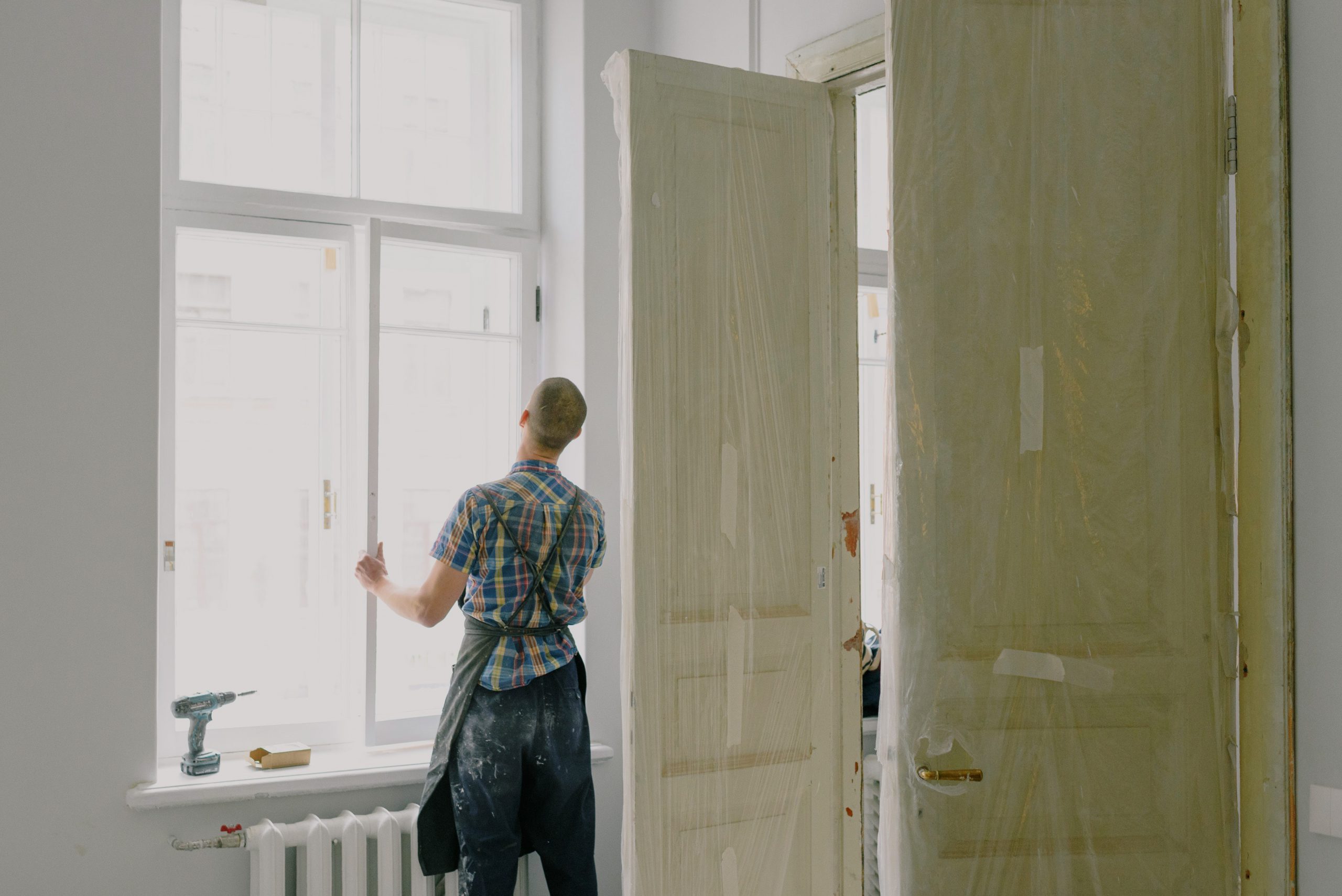 A man installing a window.