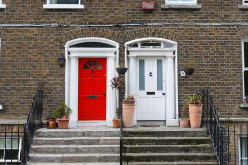 Two front doors, one red and one white.