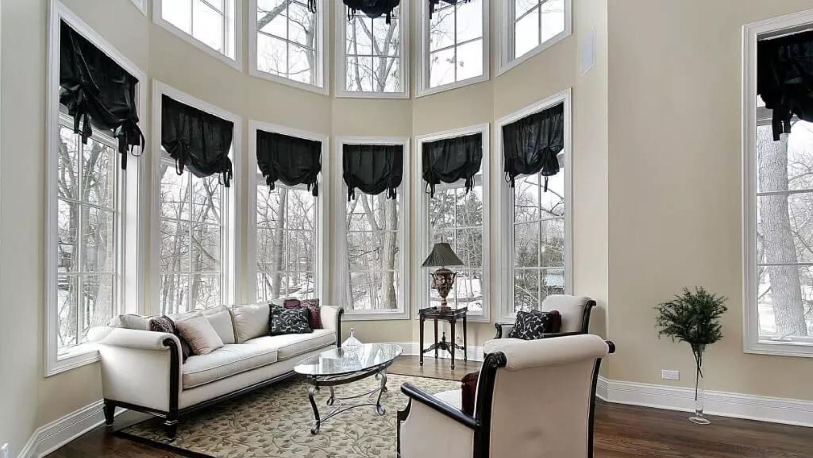 A livingroom full of tall windows.
