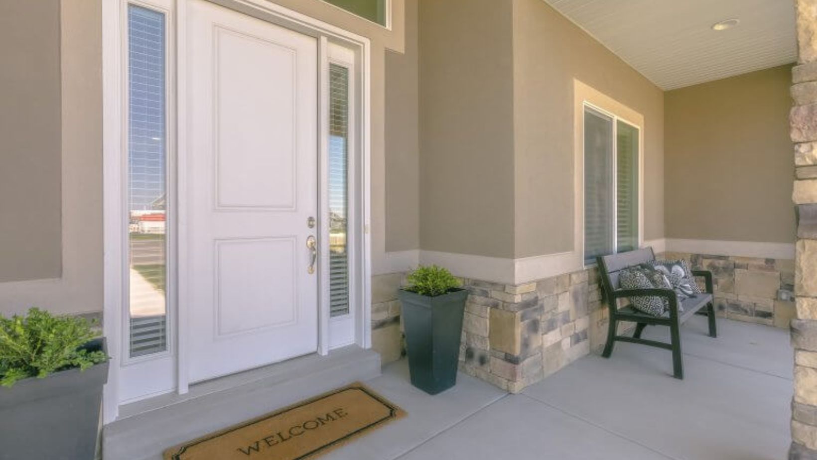 A white front door with a welcome mat.