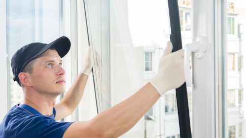 A man installing a window.