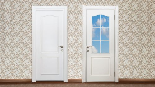 A white steel door beside a white fibreglass door.