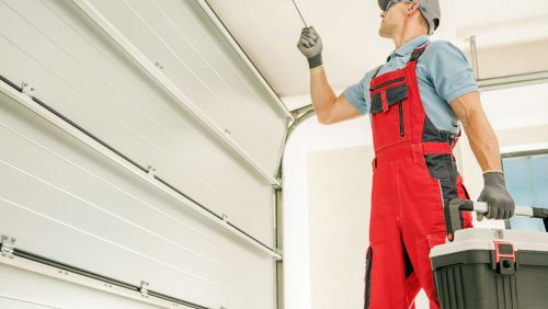 A man working on a garage door.