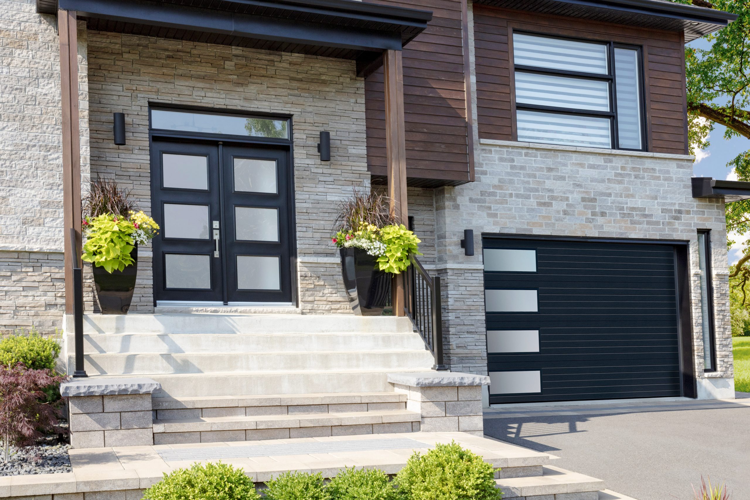 Modern black garage door and front door from Barrie's favourite windows and doors company.